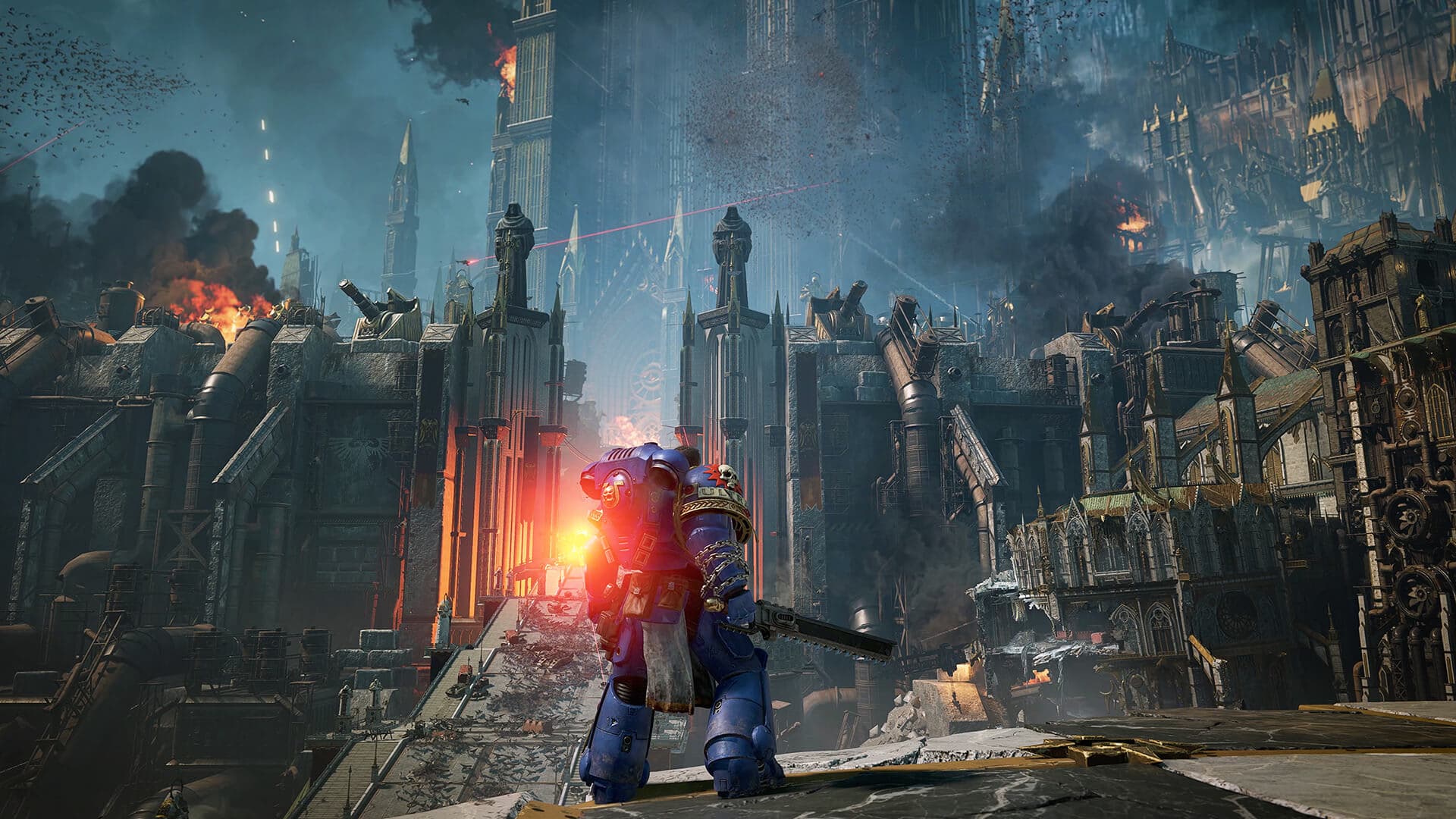 A man in large blue armour holding a sword faces away from camera and stares at the border wall of a city full of spires and pipes, as fires rage within.